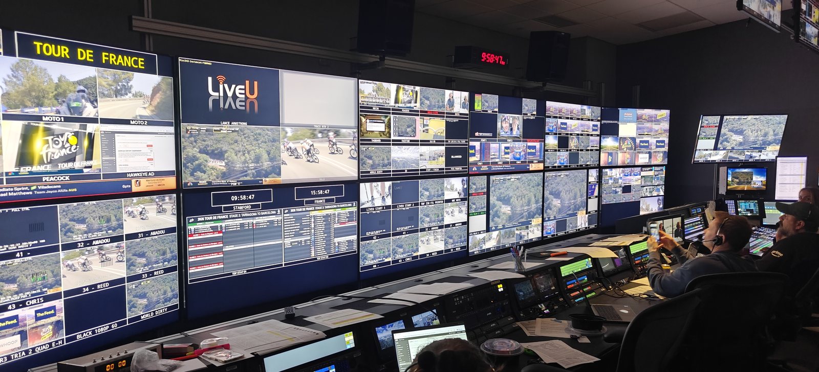 The NBC Sports Tour de France control gallery — a wall of live race feed monitors